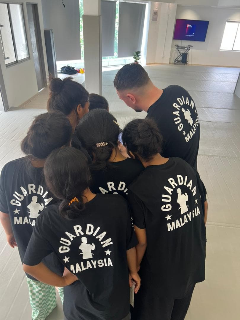 A team huddle reinforcing the core values of discipline and respect.